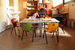 Robust, stackable chair with wooden seat shell.